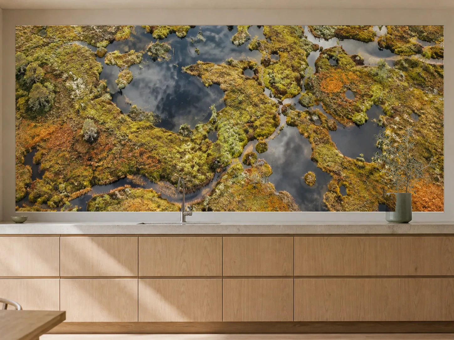 Küchenrückwand „Moorlandschaft mit dunklen Wasseraugen“ als installierte Rückwand in einer warmen Küche