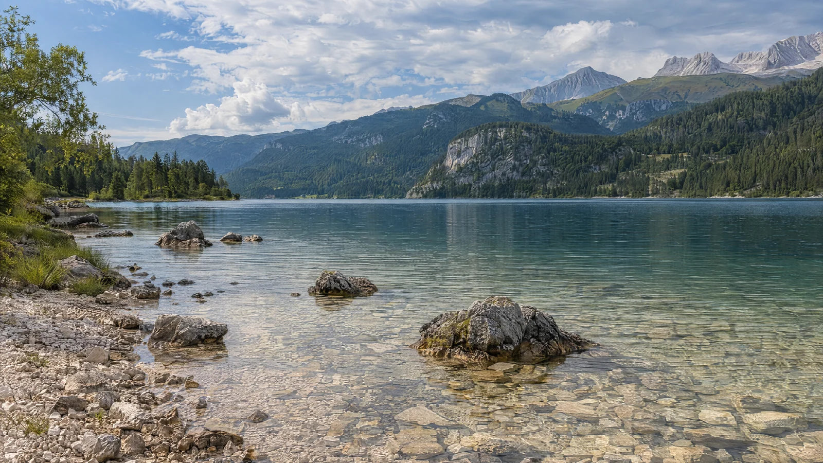 Motivvorschau „Felsufer vor spätsommerlichen Bergen“ für Küchenrückwand